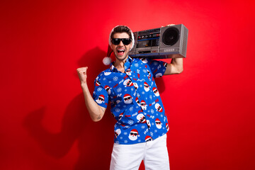 Photo of crazy guy raised fist up listen boombox tape player music lover celebrate happy new year...