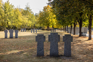 Naklejka premium Stone tombstones in the German cemetery in the fall. Beautiful German cemetery near Kyiv. Many dead German soldiers of the dead during the 2nd World War.