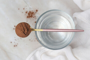 Unsweetened dark chocolate cacao powder in the spoon	