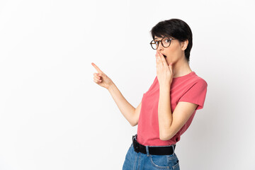 Woman with short hair isolated on white background with surprise expression while pointing side