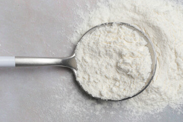 White powder in the spoon. Collagen protein powder or wheat flour. Concept of nutritional supplement, dieting, detox, preventive healthcare and healthy lifestyle.