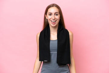 Young sport caucasian woman wearing a towel isolated on pink background with surprise facial...