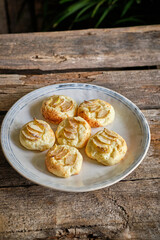 Syrnik with pear on a wooden background.
cheese pancake. 