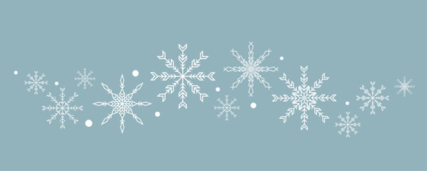Naklejka na ściany i meble Snowflakes isolated on blue background. Wave of snowflakes.