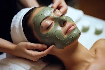 Foto op Canvas Close-up portrait of beautiful woman getting a gentle facial massage by a beautician. Cosmetologist applying treatment face mask On woman face. Spa treatments, Face peeling mask, facial care. © somsuda