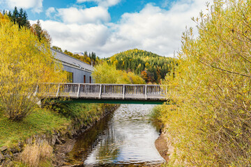 Fototapeta na wymiar Hilly landscape with bridge over mountain river
