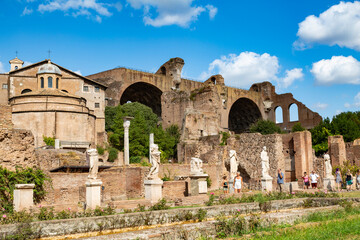 Fototapeta na wymiar Monuments of the Roman Forum with the statues of the high priestesses of Vesta and the Basilica of Maxentius and Constantine. Rome, Italy