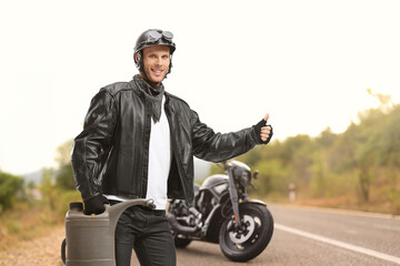 Biker holding a gas container and hitchhiking