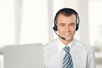 Technical support worker with a headset in modern office.