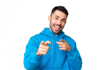 Young handsome caucasian man over isolated chroma key background surprised and pointing front