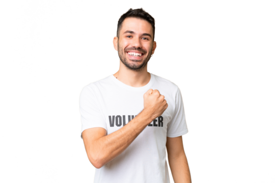 Young volunteer caucasian man over isolated chroma key background celebrating a victory - Powered by Adobe
