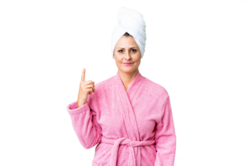 Middle age caucasian woman in a bathrobe over isolated background pointing with the index finger a great idea