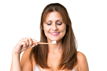 Middle age woman over isolated background with a toothbrush