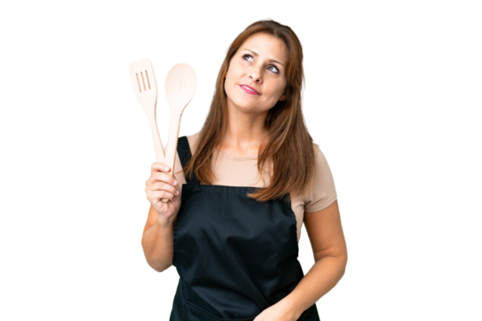Middle age caucasian woman holding a rolling pin over isolated background thinking an idea while looking up