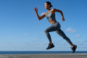 Fototapeta premium athletic brunette girl doing fitness doing exercises leading a healthy lifestyle