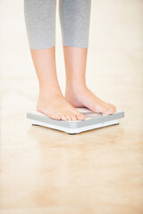Woman, weight loss and feet on scale for measurement, goal and control diet for health and wellness. Fitness, scales and person measuring, check and weighing body, mass and electronic device or tech