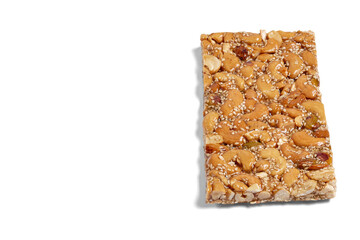 Cashew nuts, peanuts and sesame seeds bar with honey on a white background 