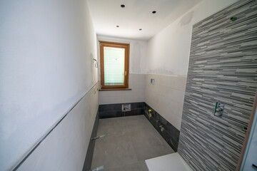 Bathroom after renovation. New stone tiles on the bath room floor.  Home renovation and improvement concept