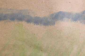 Fototapeta na wymiar Fondo astratto: pennellate di acquerello verde e blu su carta colore avana, spazio per testo