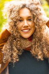 Close-up of a beauty woman with curly hair outdoors