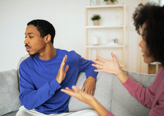 African spouses having conflict communicating their feelings at modern home
