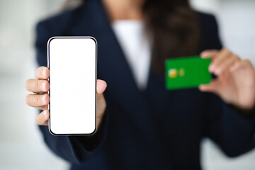 Cropped of woman using phone and credit card