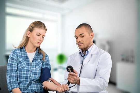 Young doctor listen to patient at clinic meeting, AI generated image
