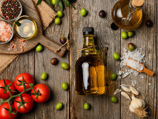 Fototapeta na wymiar olive oil and on wooden background