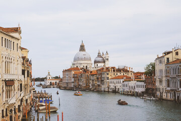 Fototapeta premium Famous view of Venice Grand Canal with Saint Mary of Health dome on sunny day from Ponte dell'Accademia bridge. Italian travel destination and landmark, tourist attraction.