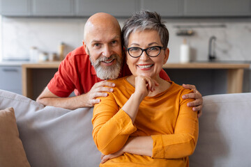 Portrait Of Happy Senior Husband And Wife Posing In Home Interior