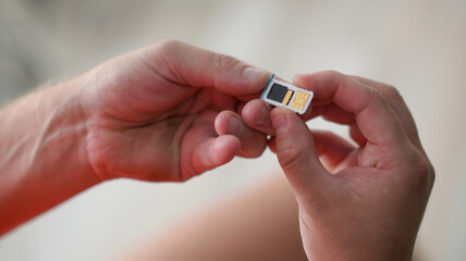 
a guy is holding a sim card in his hand together with a memory card and ready to insert into the...