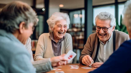 Fotobehang Retired seniors, mix of both men and women, gather in warm space to partake in card games, joying of companionship lively conversations © MYDAYcontent