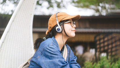 Side view portrait asian woman relax listening music with headphone for mental therapy with at...