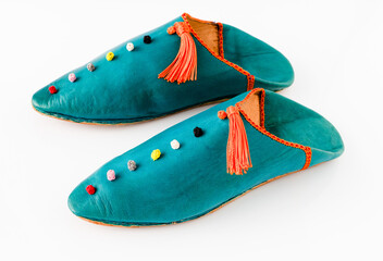 Homemade leather slippers isolated on white background. Pair of blue slipper handmade. Narrow noses, oriental style