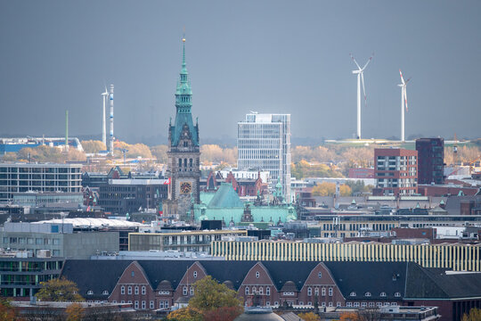 Wind energy in Hmburg. Picture shows the downtown area with the town hall in Hamburg, Germany. Wind turbines visible in the background.