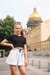 A young girl on a tourist visit to St. Petersburg against the background of St. Isaac's Cathedral