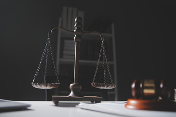 Business and lawyers discussing contract papers with brass scale on desk in office. Law, legal...