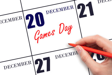 December 20. Hand writing text Games Day on calendar date. Save the date.