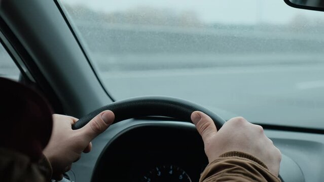 Car sharing, taxi drive concept. Cinematic shot of man driving car.