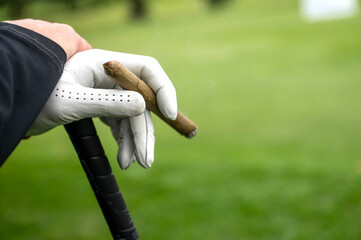 cigar in a golfers hand
