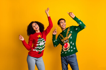Photo of pretty excited lady guy wear new year ugly print sweaters having fun enjoying disco...