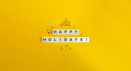 Happy Holidays Phrase on Block Letter Tiles on Bright Orange Yellow Background.