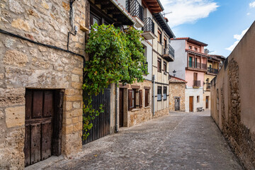 Fototapeta na wymiar Alley of quaint-looking old stone houses in the medieval village of Frias, Burgos.