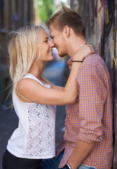 Love, city and couple hug on road for date, cute relationship and bonding outdoors on weekend. Dating, romance and happy man and woman embrace for flirting, connection and adventure in urban town