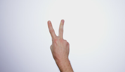 Hand, counting two and person in studio with mockup space for advertising, peace emoji, promotion or marketing. Fingers, closeup and man model with mathematics numbers gesture for empty mock up by wh
