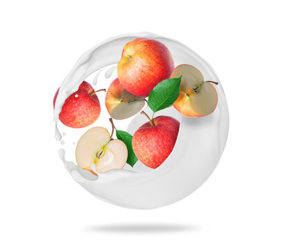 Whole and sliced apples in spherical milk splashes on a white background