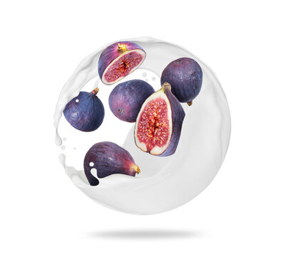 Whole and sliced ripe figs in spherical milk splashes on a white background