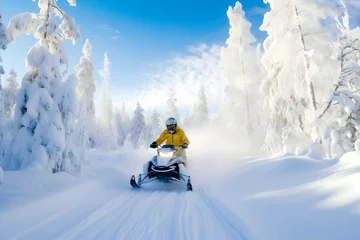 Fotobehang A man on a snowmobile in the mountains, riding on a snow-covered path among the trees © Cris