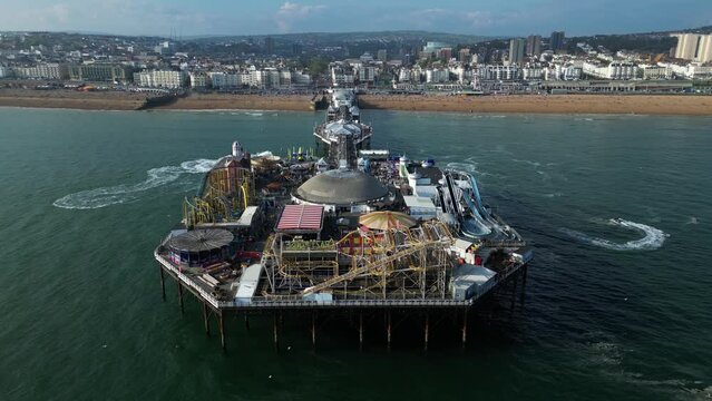 Aerial view of Brighton Palace Pier along the coastline facing the English Channel in Brighton, England, United Kingdom.