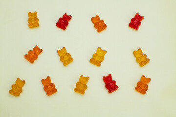 Gummy vitamins, gummy bears on yellow backgruond